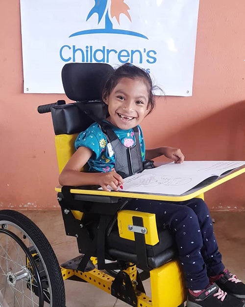 A child sitting in a wheelchair