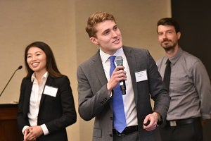 Kennedy, with teammate Mary Vu (left), makes his pitch at the 2018 LMI-Sandler Prize final round.