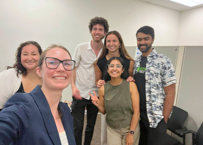 Erin Han pictured with students and Amanda Jancu